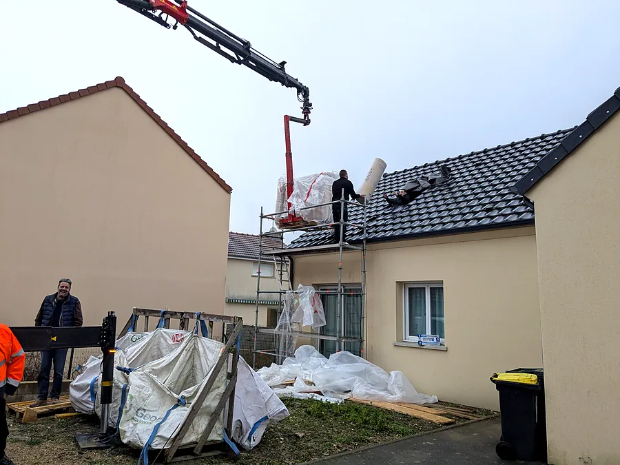 Intervention en toiture : matériaux montés à la grue sur un pavillon